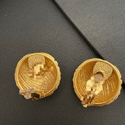 Textured gold-tone round clip-on earrings, back view