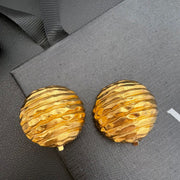 Textured gold-tone round clip-on earrings, front view