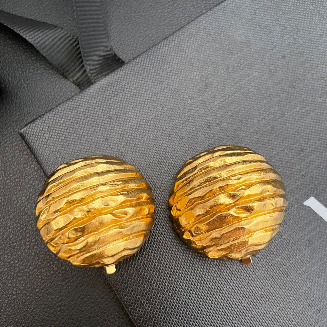 Textured gold-tone round clip-on earrings, front view
