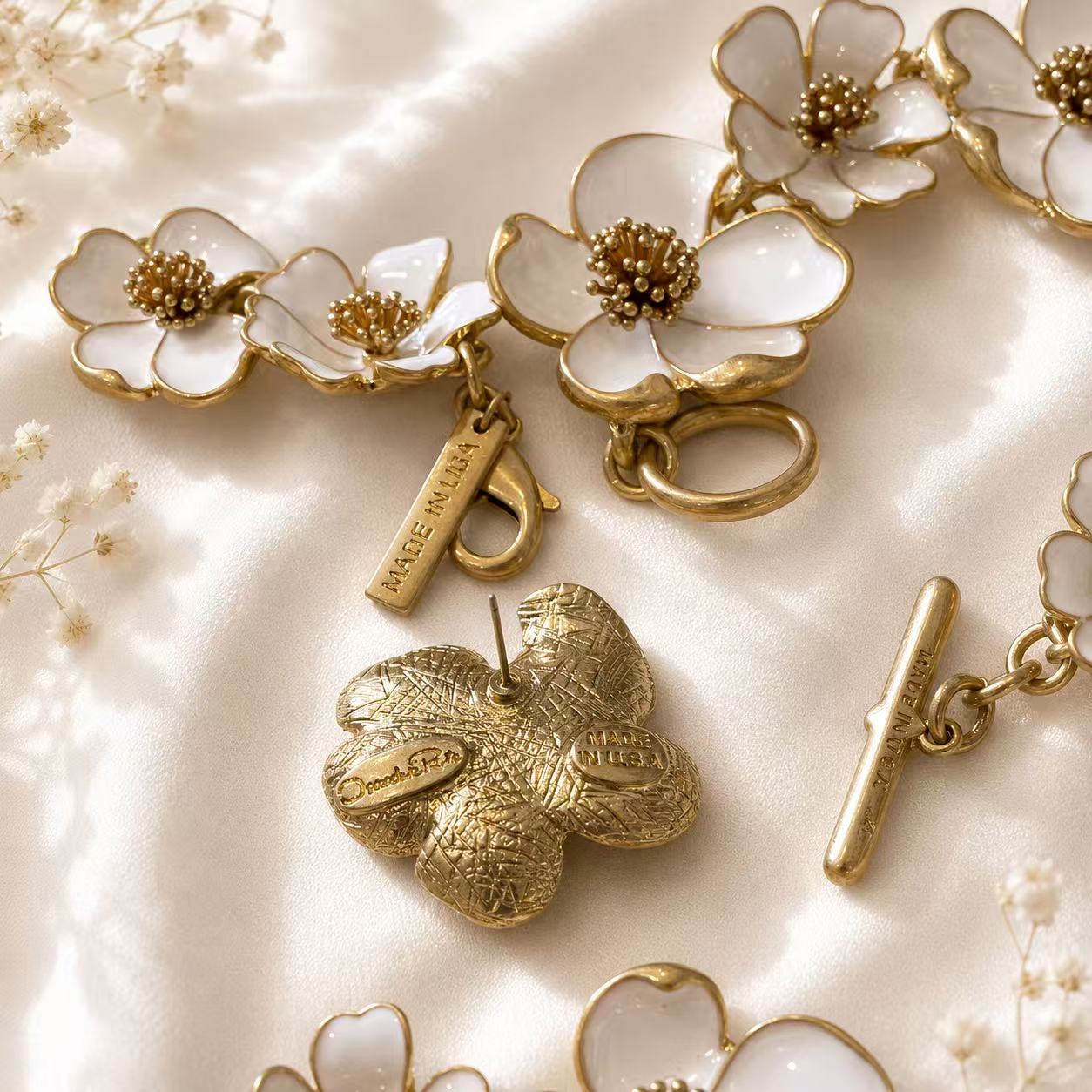 White enamel floral jewelry clasp and back view of a matching stud earring